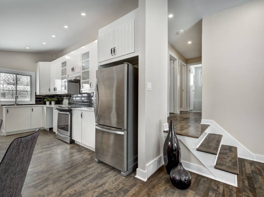 High-end custom home renovation featuring staged interiors, renovated basement, outdoor deck, and backyard