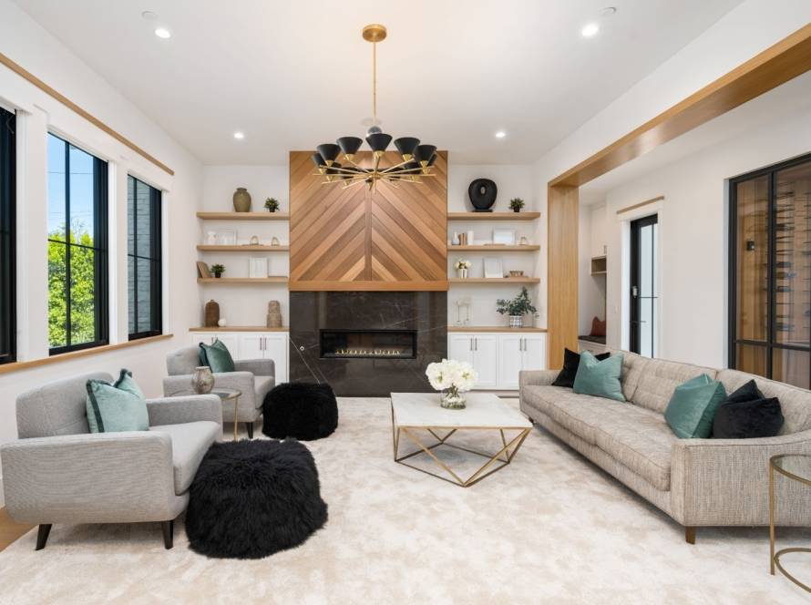 Bright living room featuring wooden walls and expansive windows that bring in natural light